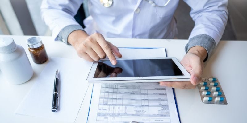 A healthcare professional using healthcare analytics tools to analyze patient data